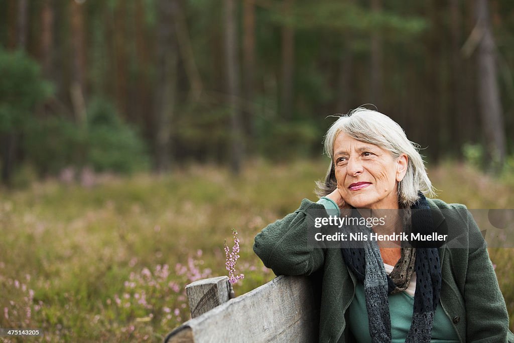 Senior woman on bench looking away