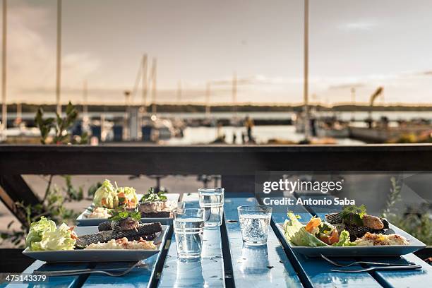 table set with meals by marina, reykjavik, iceland - reykjavik county stock pictures, royalty-free photos & images