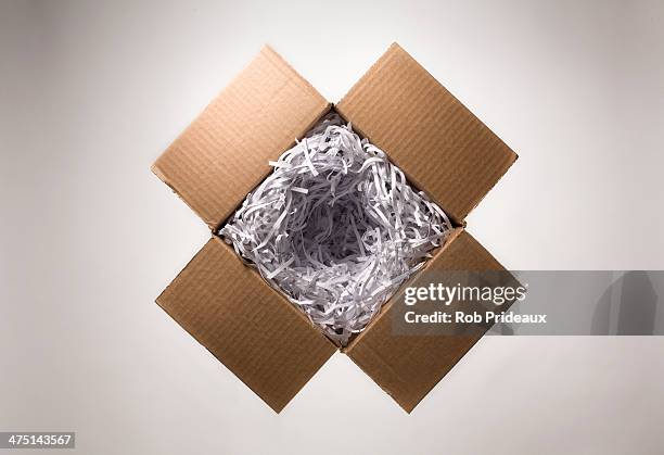 still life with open cardboard box and shredded paper - torn gift stock pictures, royalty-free photos & images