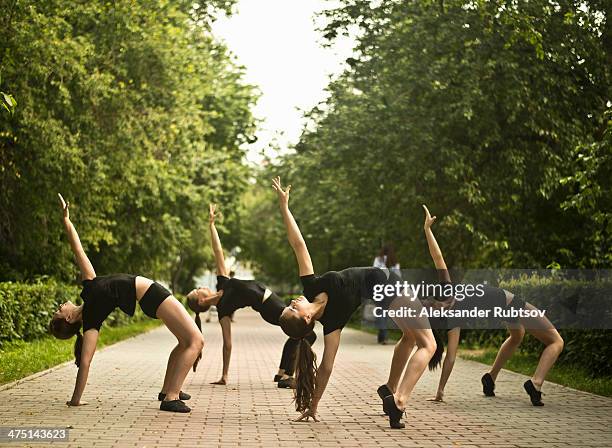 four young ballet dancers exercising in park - ballet dancers russia stock-fotos und bilder