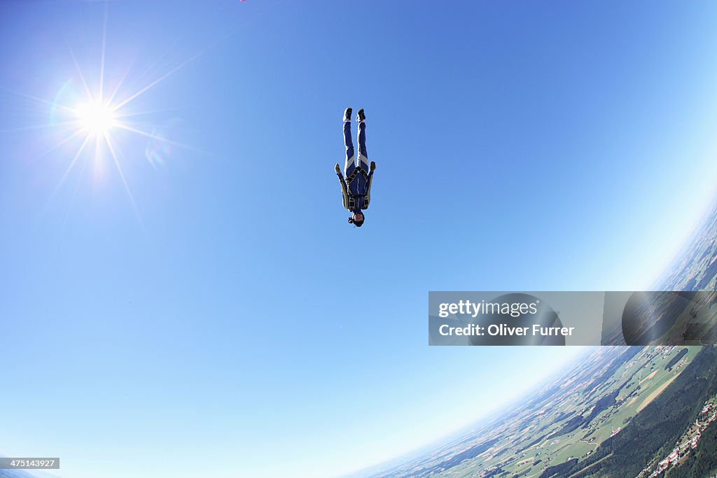 Female skydiver free falling head first above Leutkirch, Bavaria, Germany