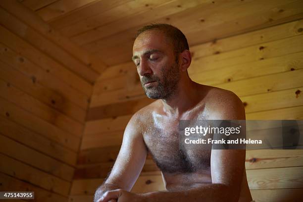 mature man sitting in sauna with head down - sauna ストックフォトと画像