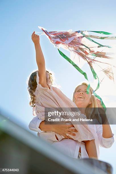 mother and daughter playing with kite, utvalnas, gavle, sweden - wooden kite stock pictures, royalty-free photos & images