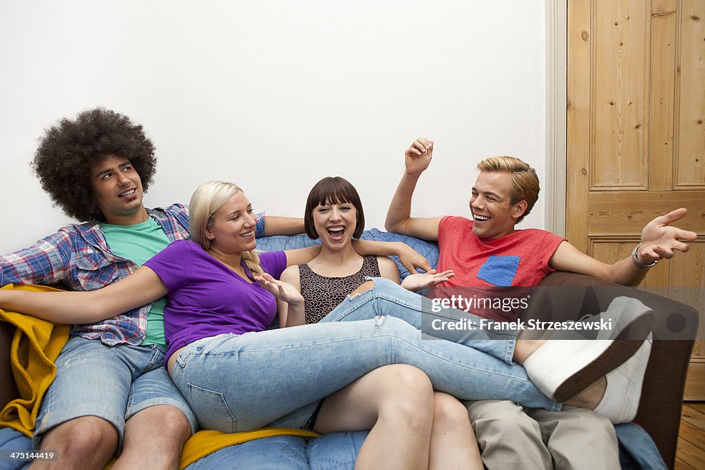 Flatmates reclining on sofa