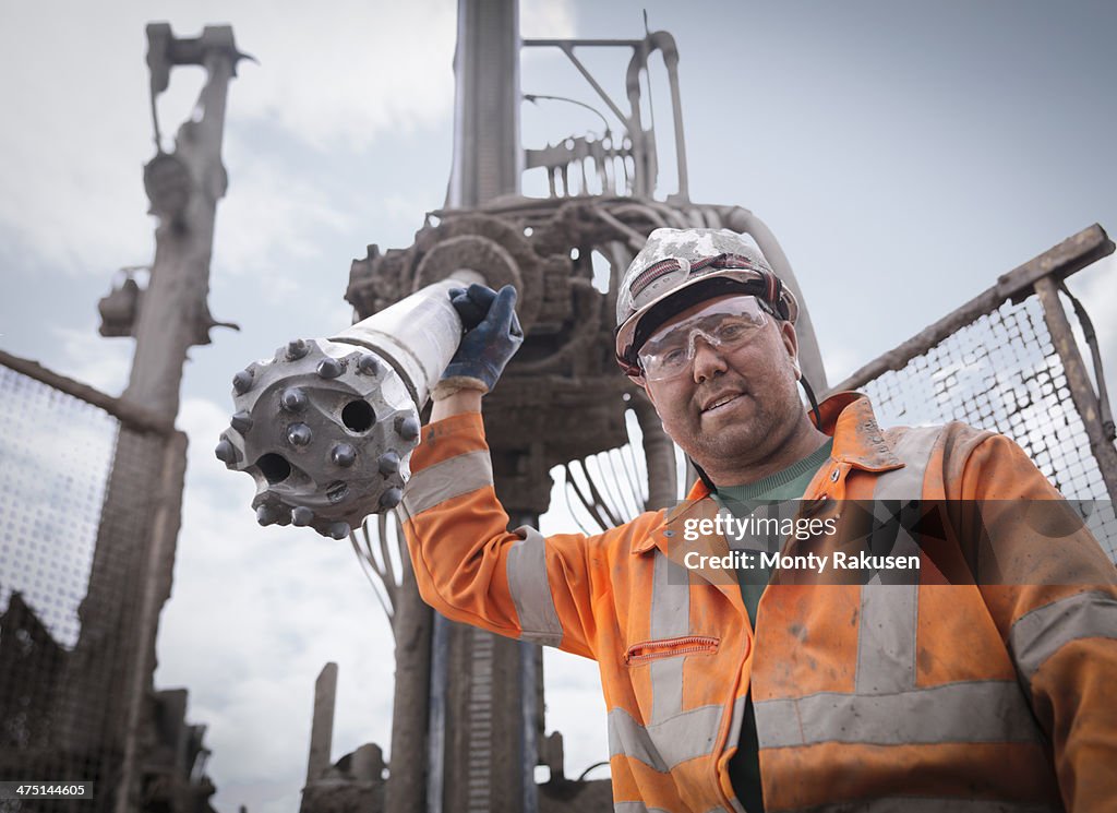 Portrait of drilling rig worker in hard hat and workwear