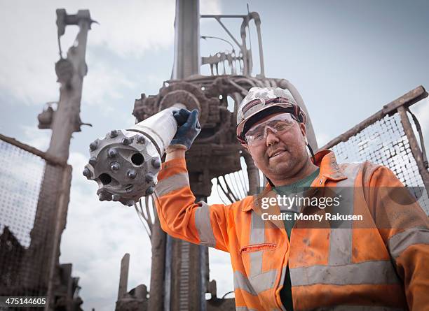 portrait of drilling rig worker in hard hat and workwear - oil rig engineers stock pictures, royalty-free photos & images
