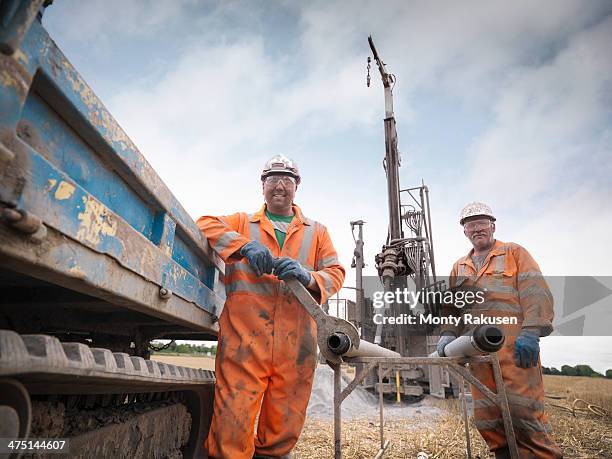 portrait of drilling rig workers in hard hats and workwear - mining hats stock pictures, royalty-free photos & images