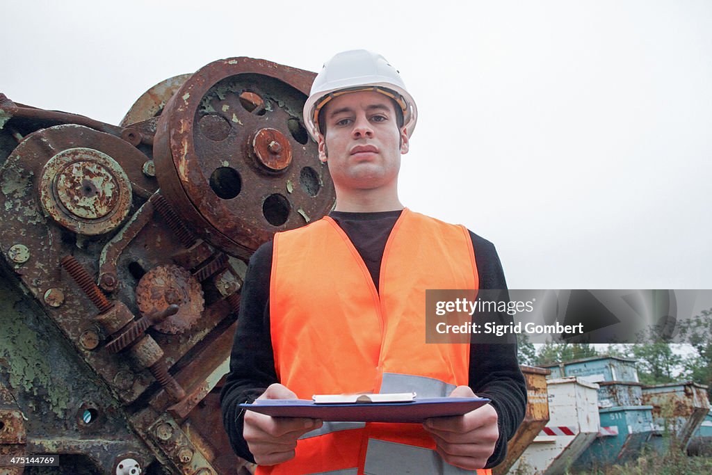 Manual worker wearing high vis vest and hard hat