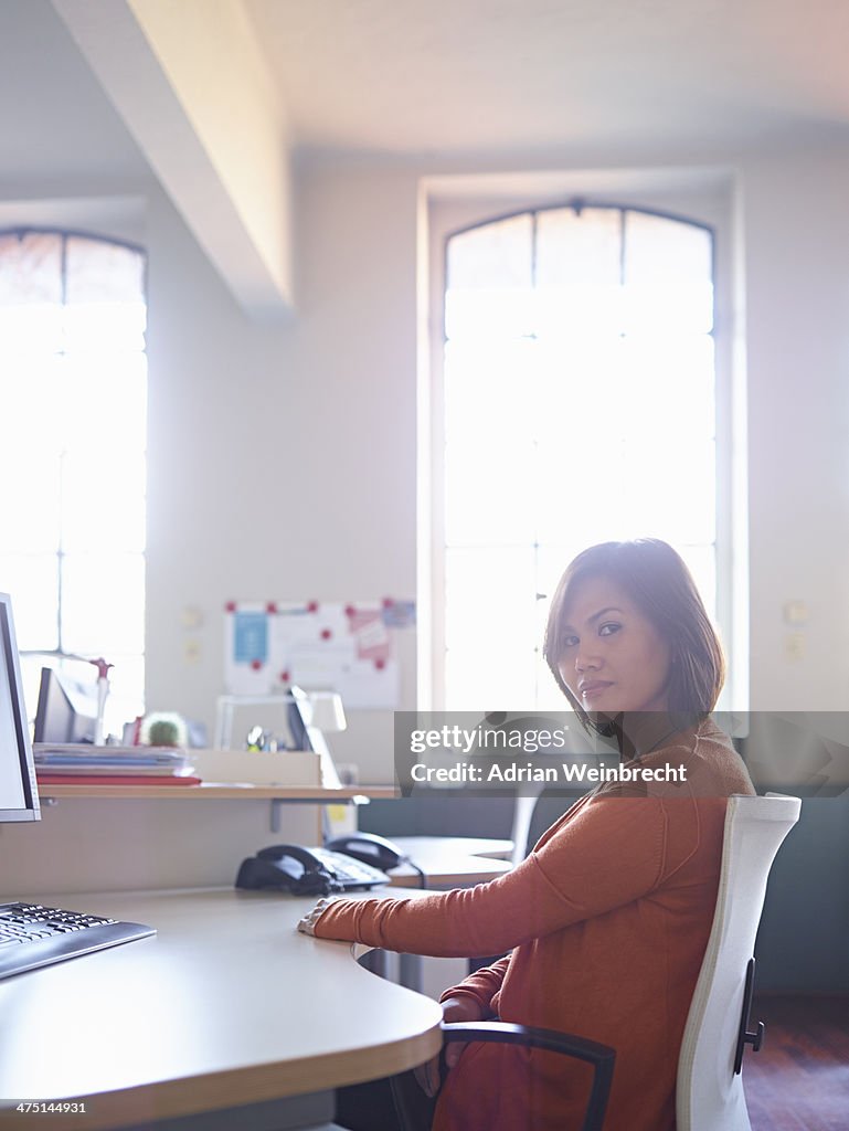 Female office worker sitting at desk