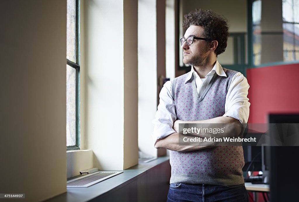 Mid adult man looking out of window