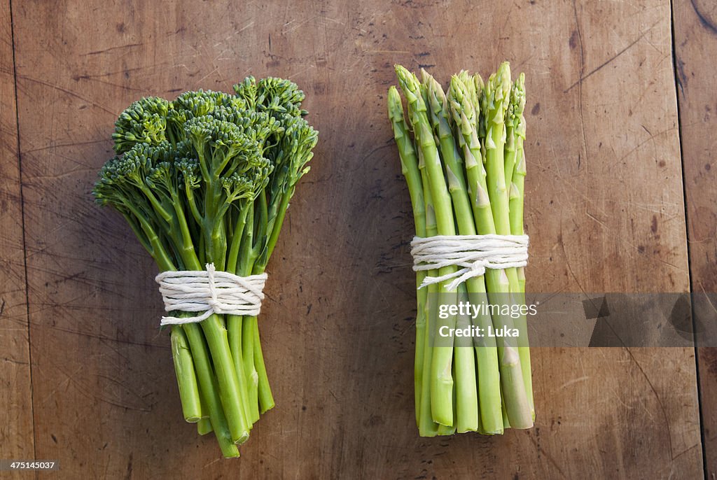 Bunches of broccoli and asparagus tied with string, still life