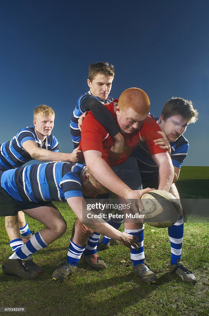 Young men playing rugby