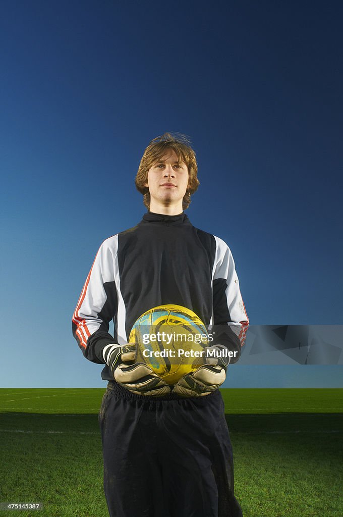 Portrait of goalkeeper holding football