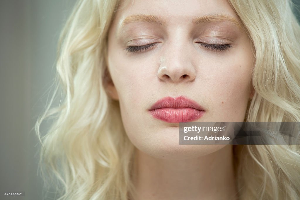 Young woman with eyes closed