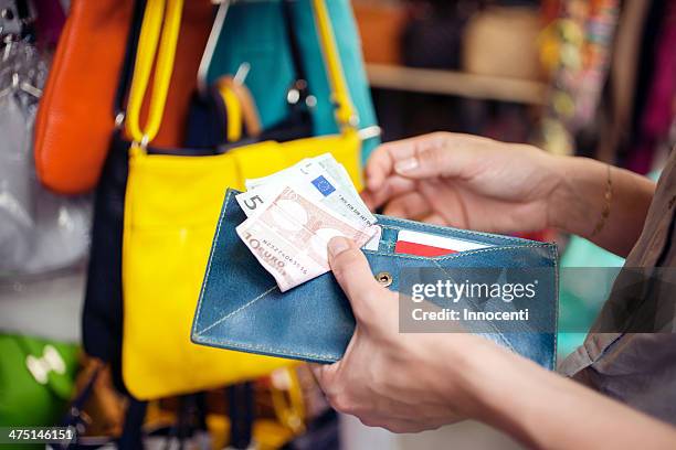young woman buying handbag, san lorenzo market, florence, tuscany, italy - money attraction stock pictures, royalty-free photos & images
