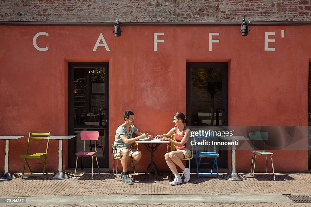 Couple sitting outside cafe, Florence, Tuscany, Italy