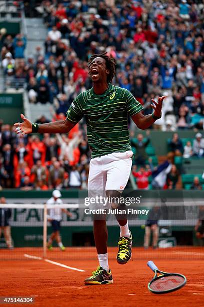 Gael Monfils of France celebrates match point in his Men's Singles match against Pablo Cuevas of Uruguay on day six of the 2015 French Open at Roland...