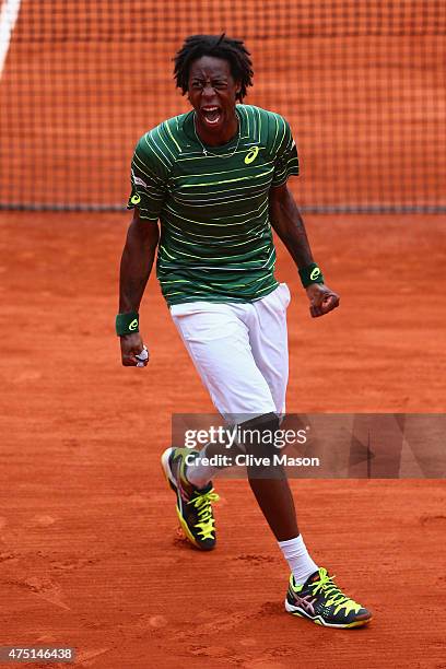 Gael Monfils of France celebrates match point in his Men's Singles match against Pablo Cuevas of Uruguay on day six of the 2015 French Open at Roland...