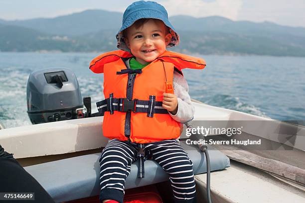 boy enjoying boat ride - life jacket stock pictures, royalty-free photos & images