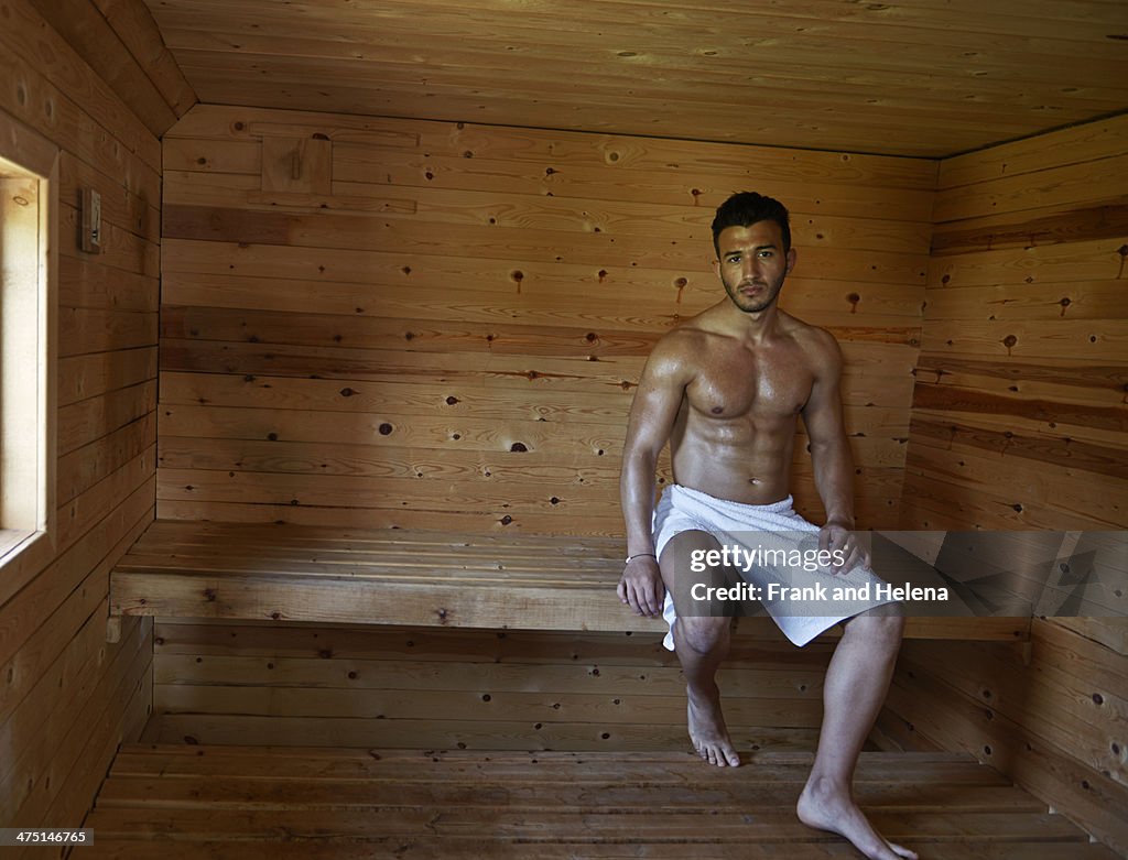 Portrait of muscular young man in sauna