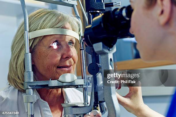 female patient having eye tested in hospital - augenuntersuchung stock-fotos und bilder