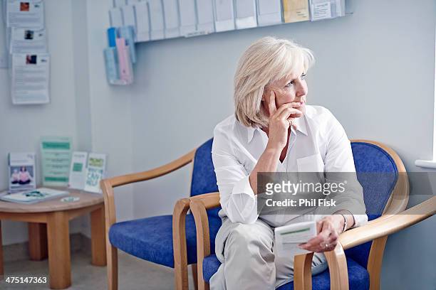 mature female patient in hospital waiting room - bulletin board flyer stock pictures, royalty-free photos & images