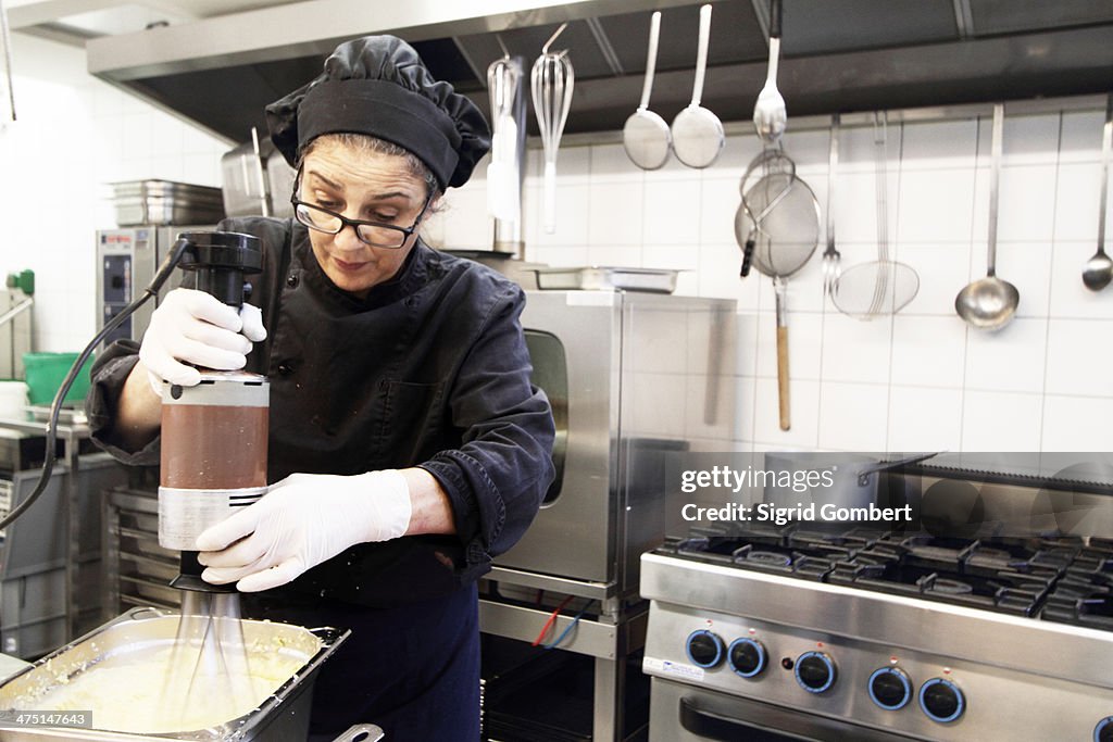 Woman working in restaurant kitchen
