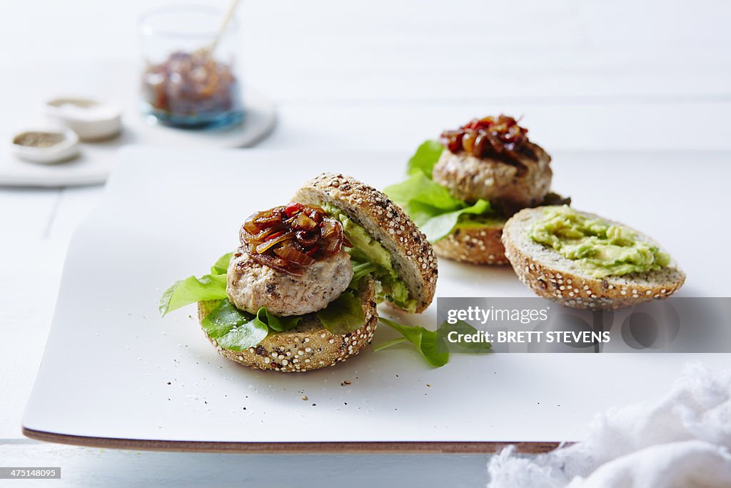 Still life of chicken and avocado burgers