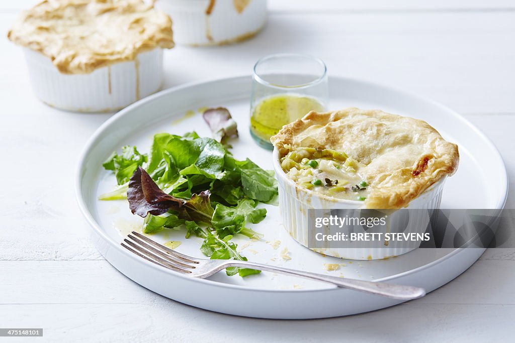 Still life of chicken, leek and pea pies