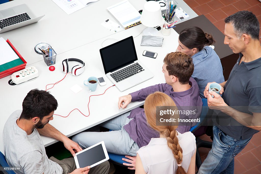 Colleagues working in office, high angle