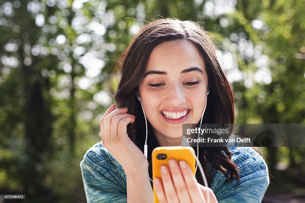 Portrait of young woman listening to music