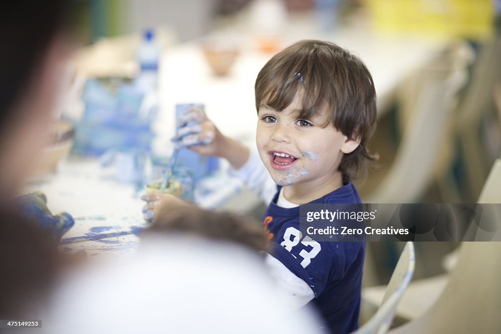 Toddler playing happily in art class