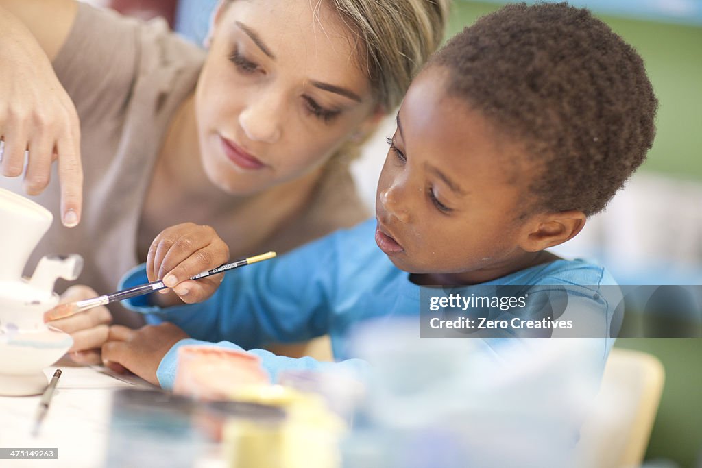 Teacher and girl in art class