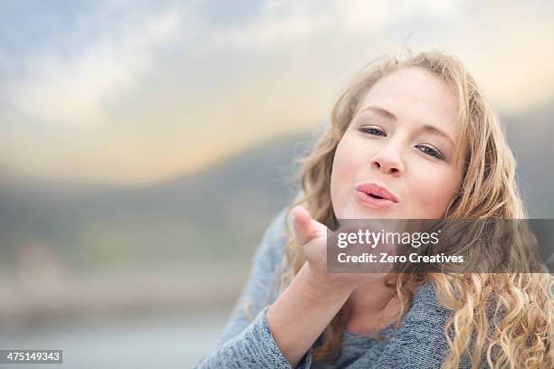 woman blowing a kiss, hout bay, cape town, south africa - mandare un bacio foto e immagini stock