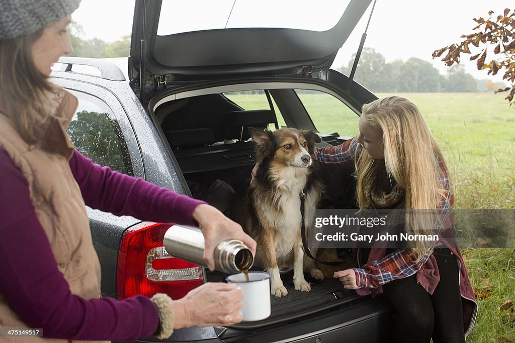 Senior woman and granddaughter with dog