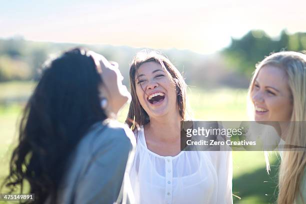 three young women having fun in park - blouse stockfoto's en -beelden
