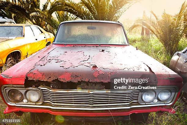 front view of vintage car in scrap yard - rusty old car fotografías e imágenes de stock