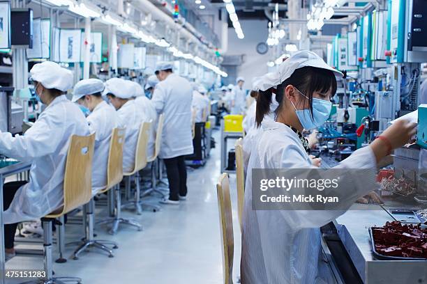 group of workers at small parts manufacturing factory in china, wearing protective clothing, hats and masks - occupation hats stock pictures, royalty-free photos & images