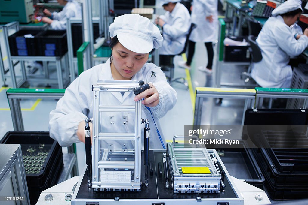 Worker at small parts manufacturing factory in China