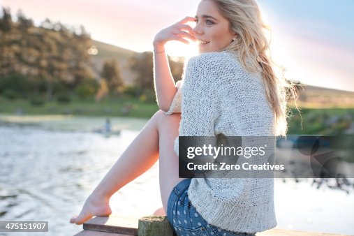 Young woman sitting on pier Young woman sitting on pier