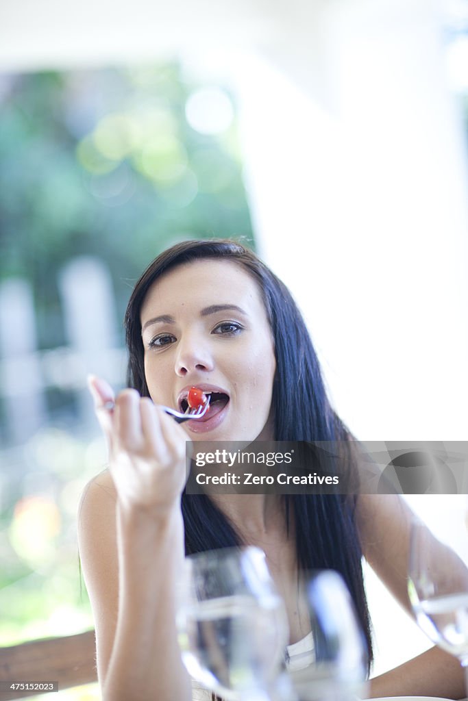 Portrait of young woman eating