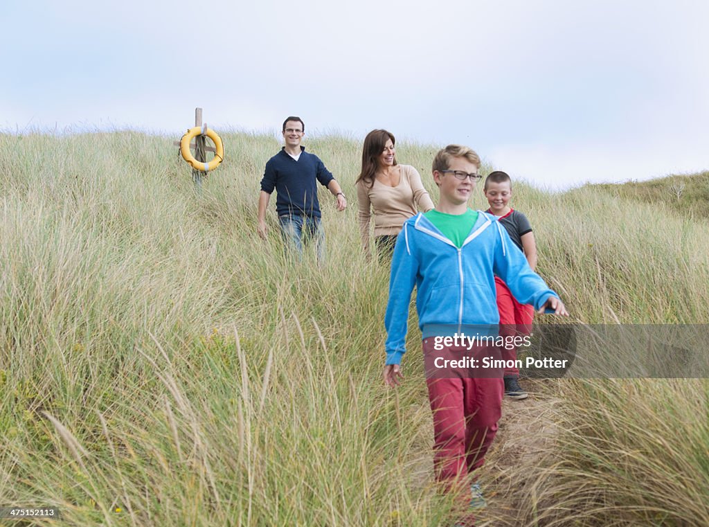Family strolling coastal path