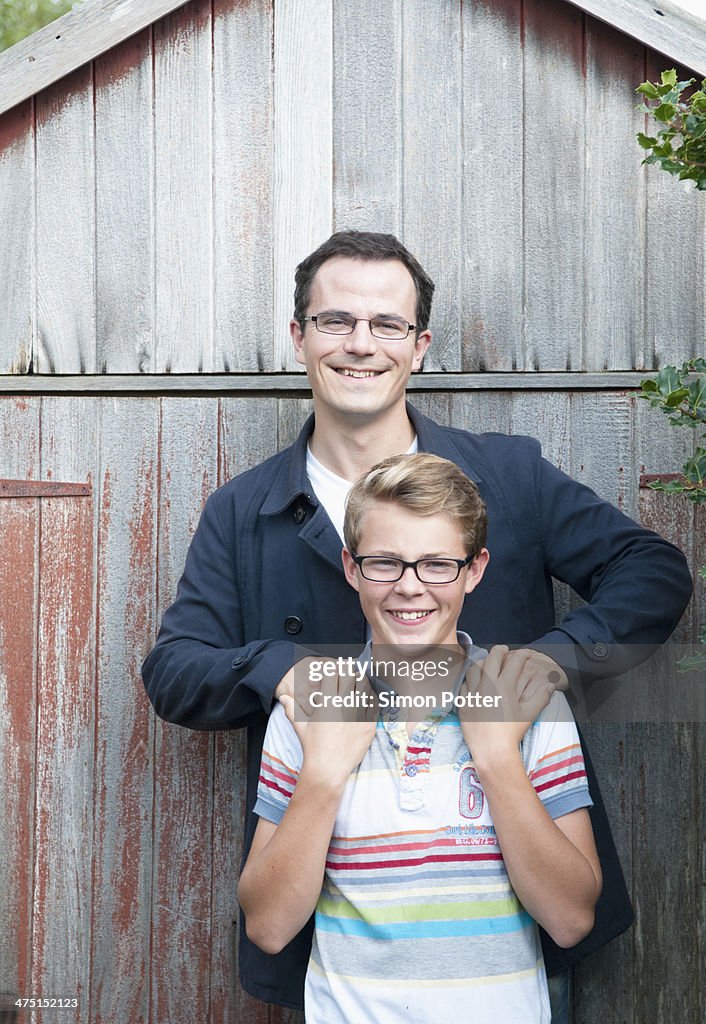 Portrait of father and teenage son in garden