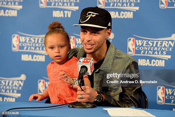 Stephen Curry of the Golden State Warriors speaks to the media with daughter Riley Curry after a game against the Houston Rockets in Game Five of the...