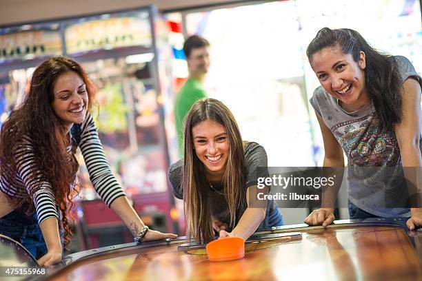 group of friends at the amusement arcade - arcade stock pictures, royalty-free photos & images