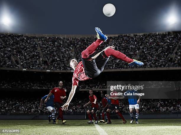 soccer player kicking ball on field - bicycle kick stock pictures, royalty-free photos & images