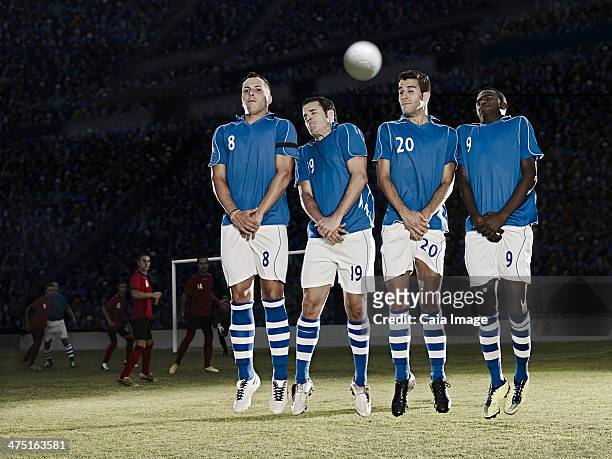 soccer players jumping on field - male crotch stock pictures, royalty-free photos & images