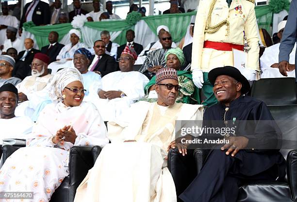 Nigerian president Muhammadu Buhari sits with Aisha Buhari, the new first lady of Nigeria and outgoing president Goodluck Jonathan during his...