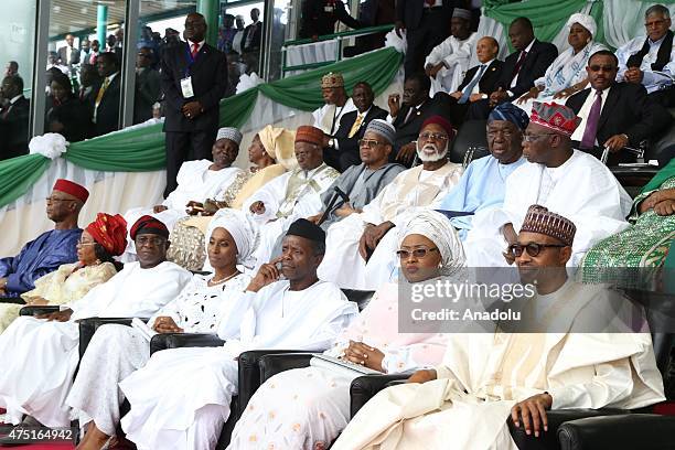 Nigerian president Muhammadu Buhari sits with Vice President-elect Yemi Osinbajo, and Aisha Buhari, the new first lady of Nigeria during his...