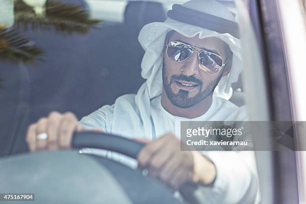 emirati man driving his car - arab car stock pictures, royalty-free photos & images